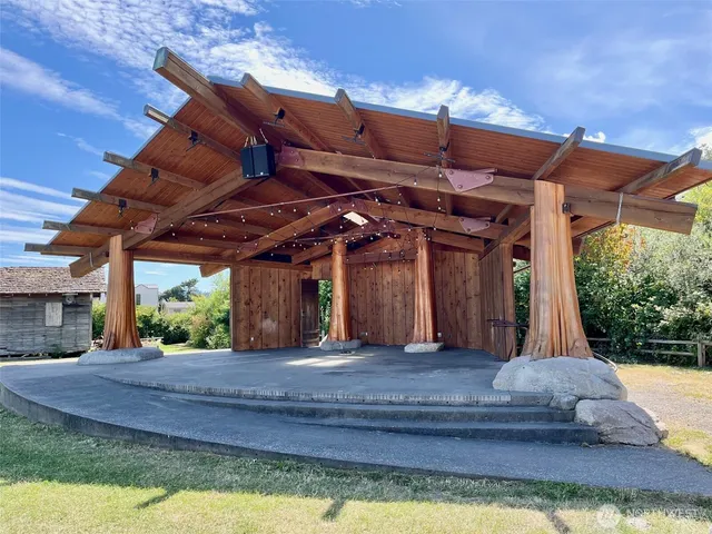 a front view of a house with a garden and a car park