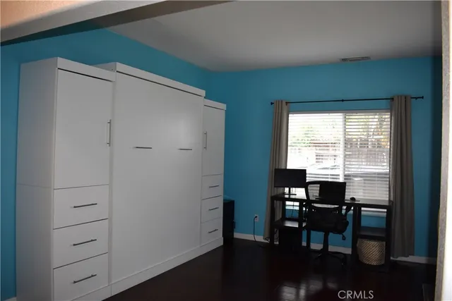 a bed sitting in a bedroom next to a window