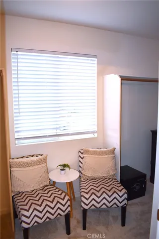 a view of bedroom with furniture and a window