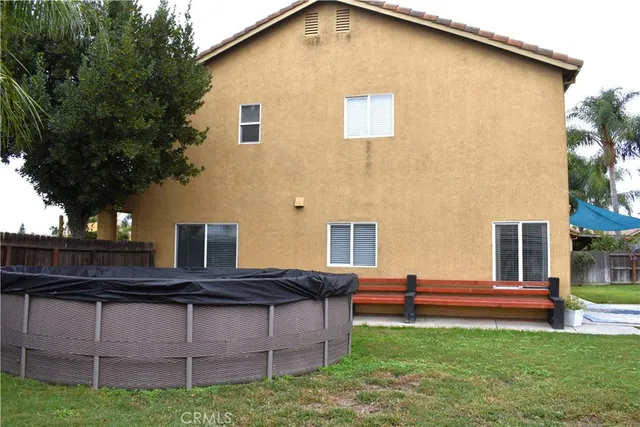 a view of a backyard with a garden and deck