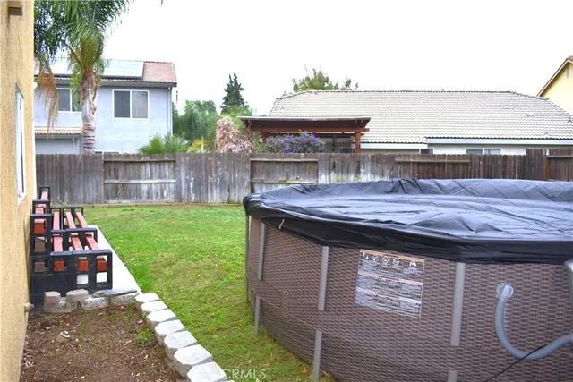 a backyard of a house with wooden floor and fence