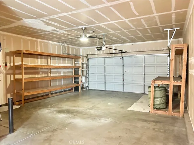 a backyard of a house with barbeque oven table and chairs