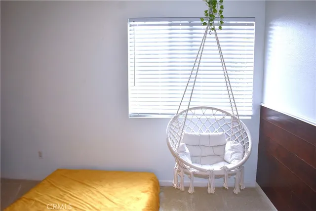 a view of a backyard with couches plants and large tree