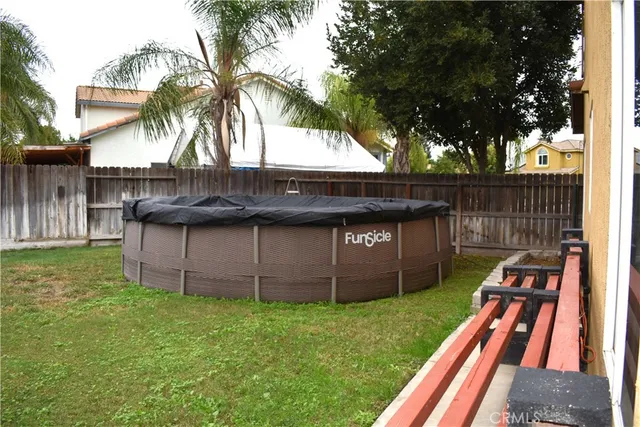 a view of a house with a yard and tree