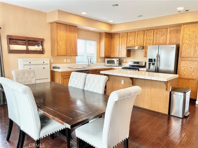 a large kitchen with kitchen island a dining table and chairs
