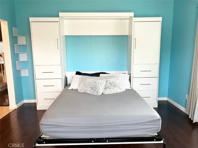 a bed sitting in a bedroom next to a window