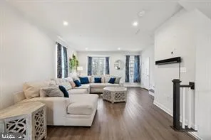 a living room with furniture window and wooden floor