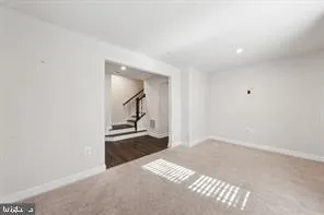 a view of a room with wooden floor and staircase