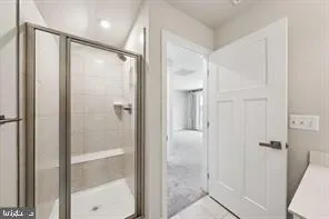 a bathroom with a glass shower door