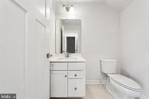 a bathroom with a toilet a sink and mirror