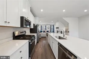 a kitchen with a sink stove and cabinets