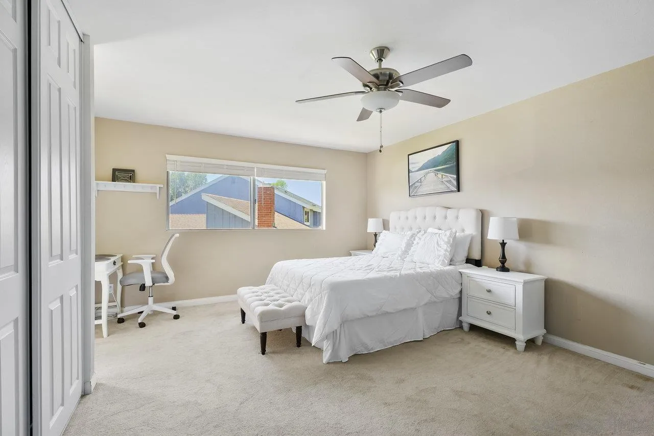 231 Blossom Way Oceanside, CA 92058 - Photo 13 of 31 a bedroom with a bed and a chandelier