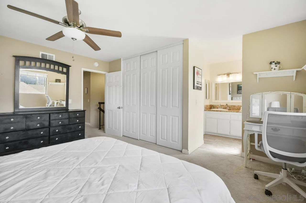 231 Blossom Way Oceanside, CA 92058 - Photo 15 of 31 a bedroom with a bed a dresser and a chandelier