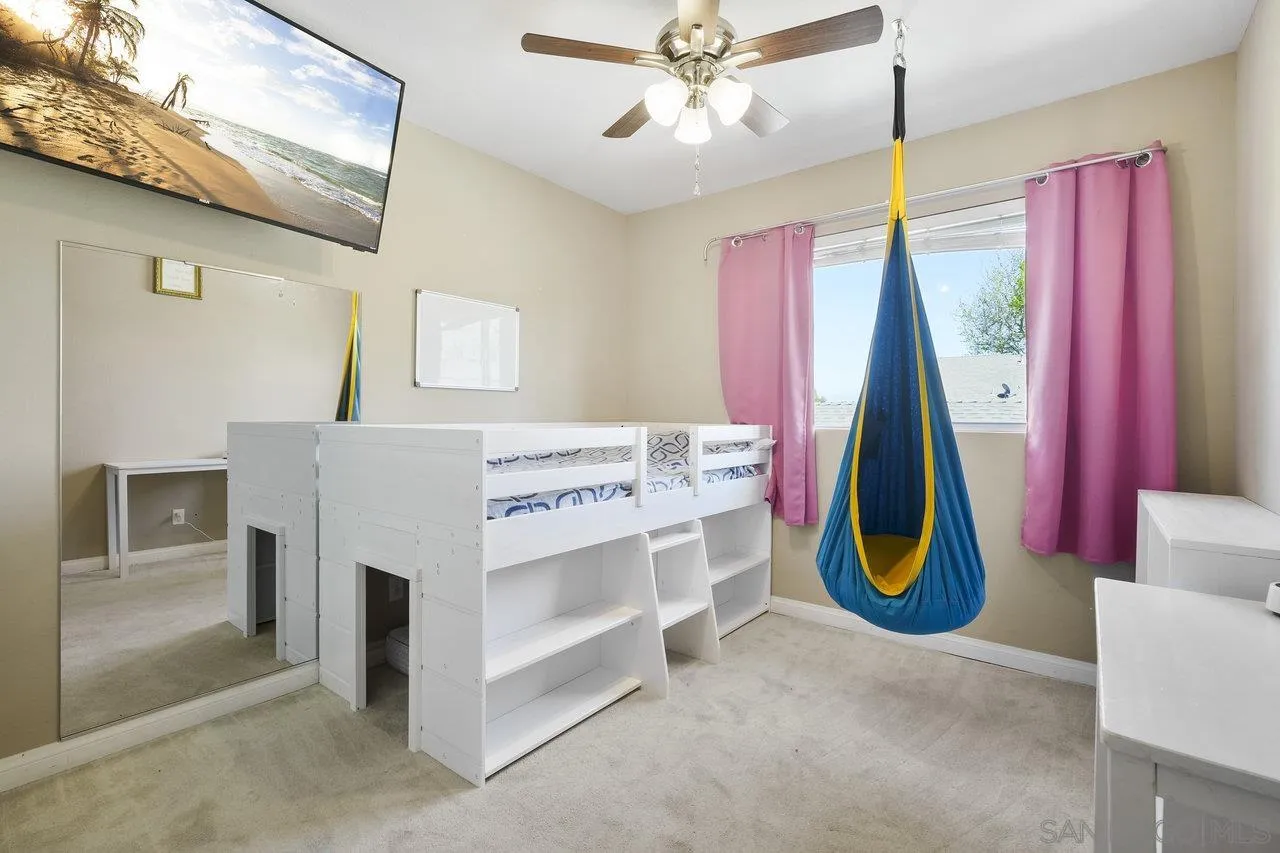 231 Blossom Way Oceanside, CA 92058 - Photo 19 of 31 a view of a bedroom with furniture and a chandelier