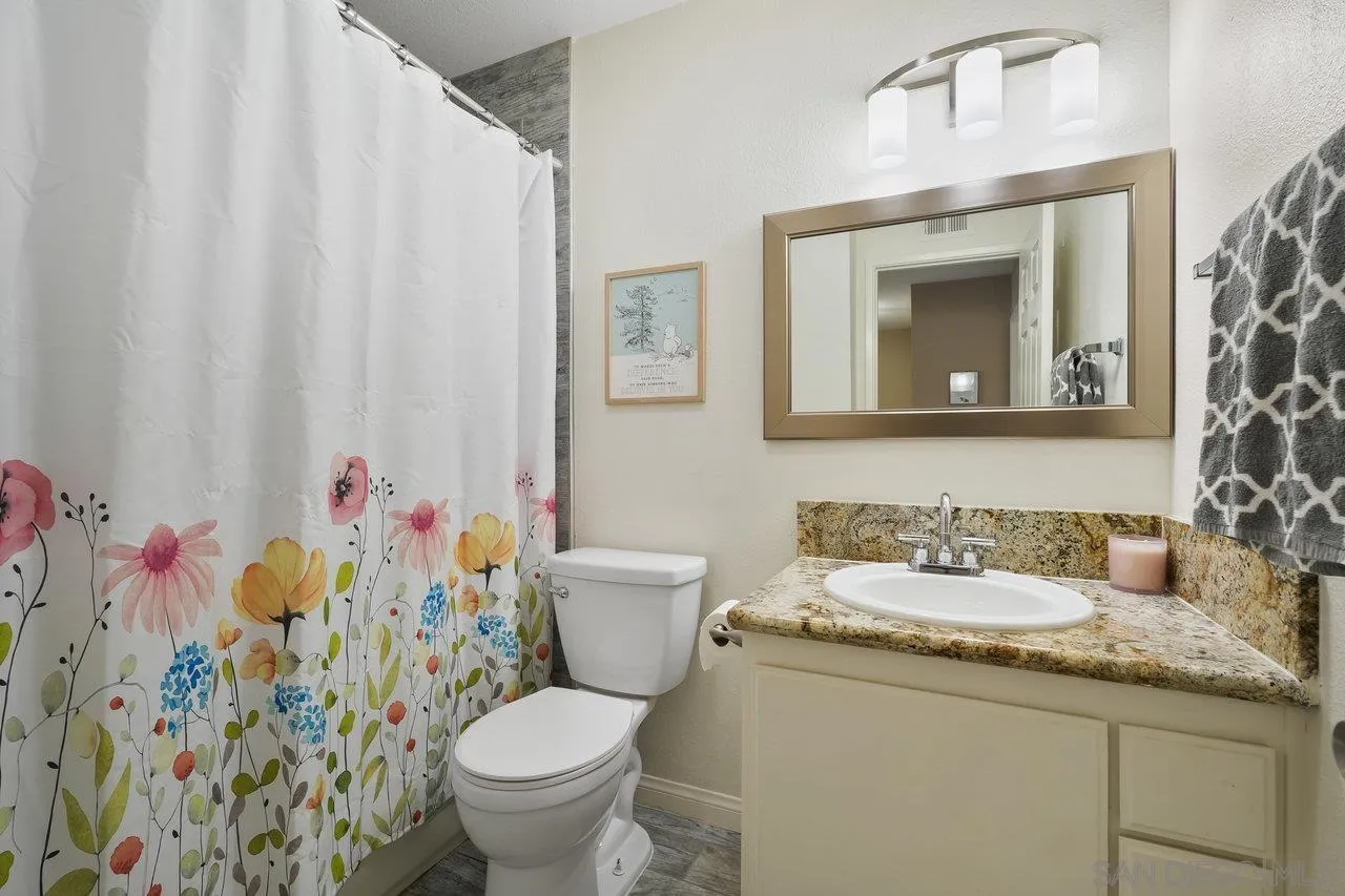 231 Blossom Way Oceanside, CA 92058 - Photo 21 of 31 a bathroom with a granite countertop toilet sink and mirror
