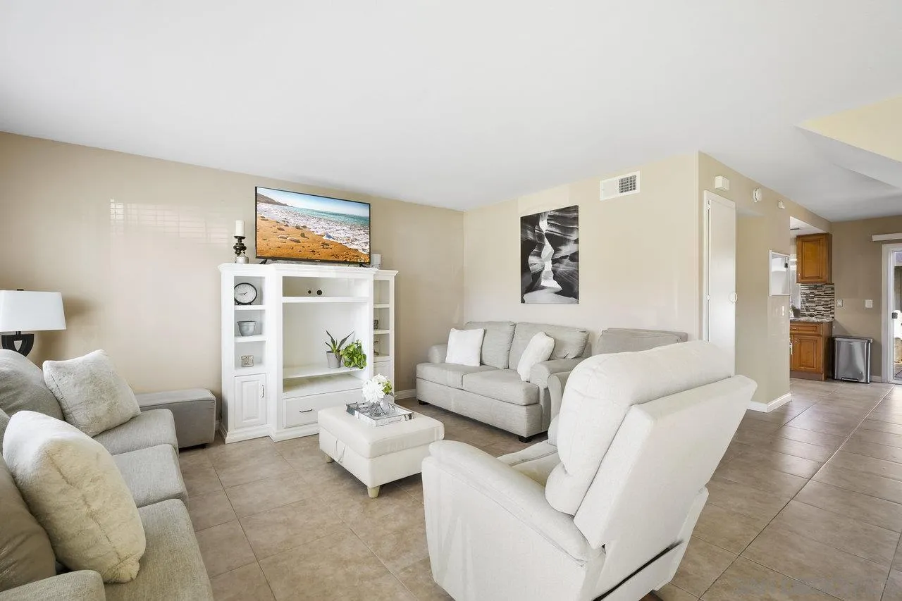 231 Blossom Way Oceanside, CA 92058 - Photo 6 of 31 a living room with furniture and a flat screen tv