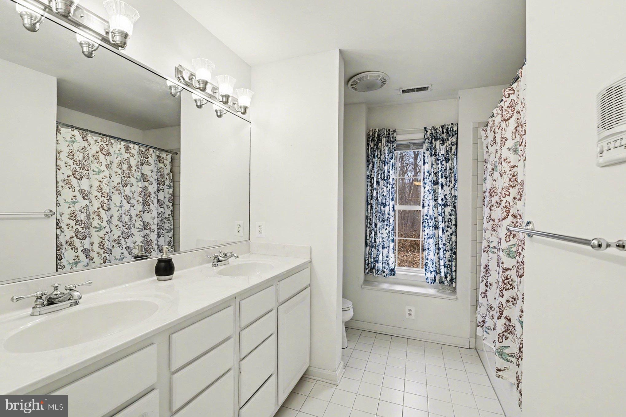 1645 Timber Summit Drive Westminster, MD 21157 - Photo 30 of 52 a bathroom with a double vanity sink mirror and shower