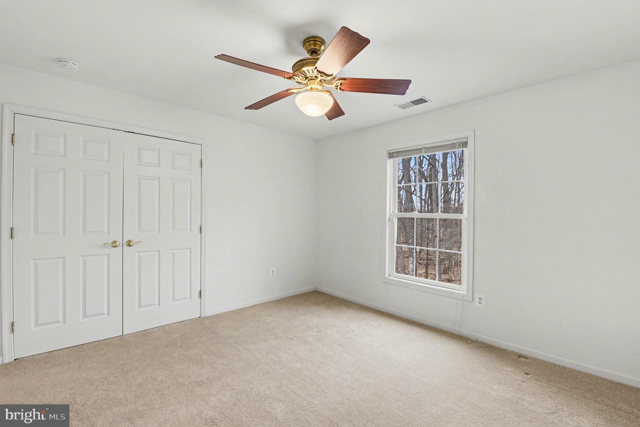 1645 Timber Summit Drive Westminster, MD 21157 - Photo 40 of 52 an empty room with windows and fan