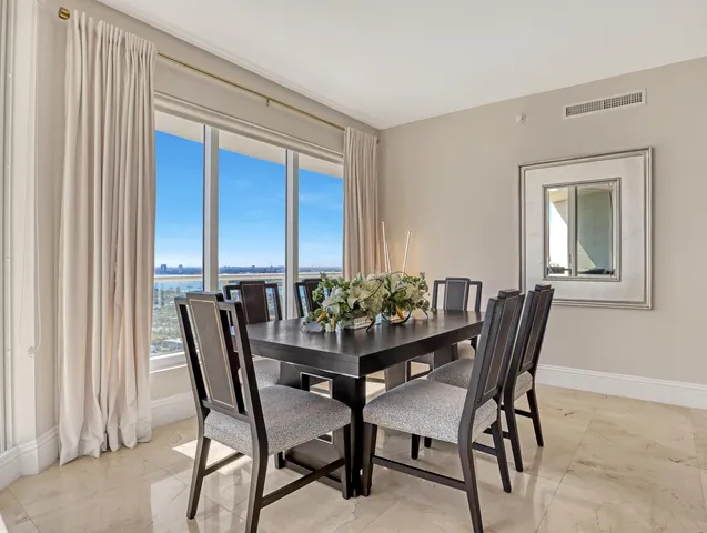 a kitchen with stainless steel appliances granite countertop a sink and a refrigerator