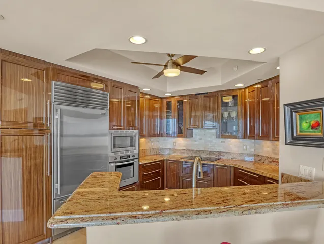 a kitchen with granite countertop stainless steel appliances and cabinets