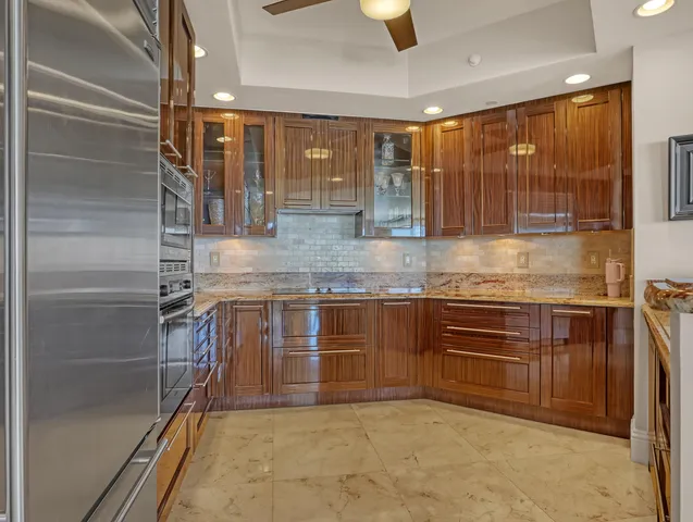 a utility room with stainless steel appliances granite countertop a sink and dishwasher