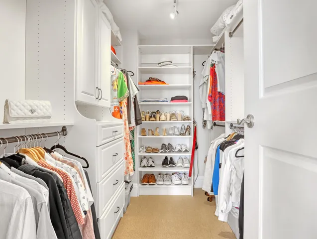 a view of a bedroom with a large window and front door
