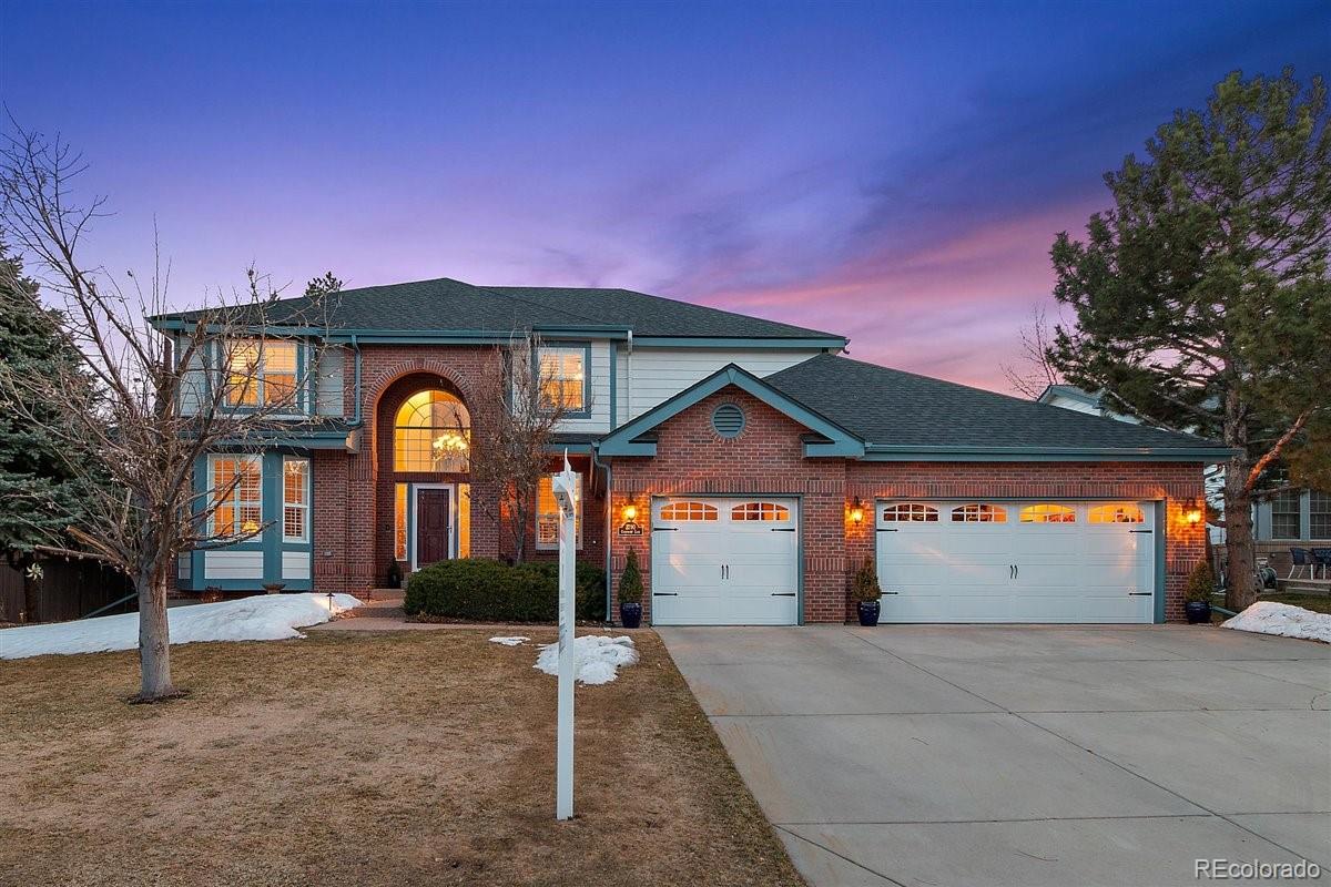 2290 Crestmont Lane Highlands Ranch, CO 80126 - Photo 1 of 40 a front view of a house with a yard and garage