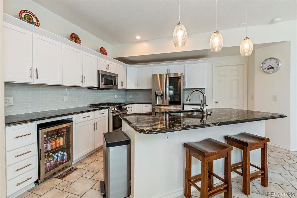 2290 Crestmont Lane Highlands Ranch, CO 80126 - Photo 11 of 40 a kitchen with stainless steel appliances granite countertop a sink and cabinets