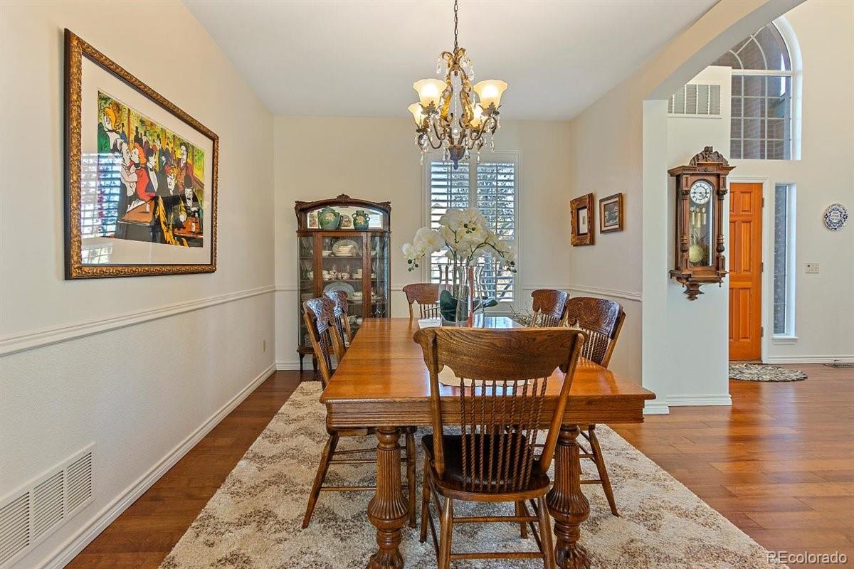 2290 Crestmont Lane Highlands Ranch, CO 80126 - Photo 14 of 40 a dining room with furniture a chandelier and wooden floor