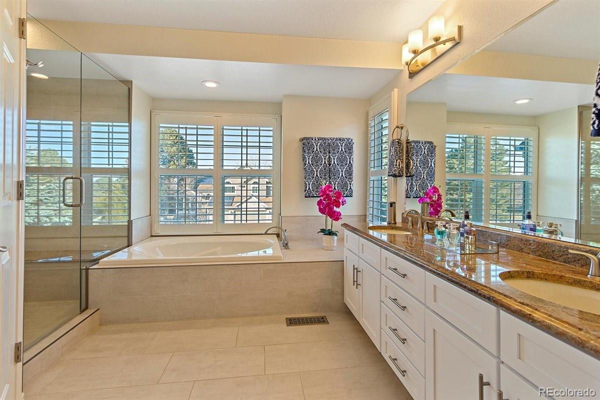 2290 Crestmont Lane Highlands Ranch, CO 80126 - Photo 20 of 40 a spacious bathroom with a tub sink and mirror