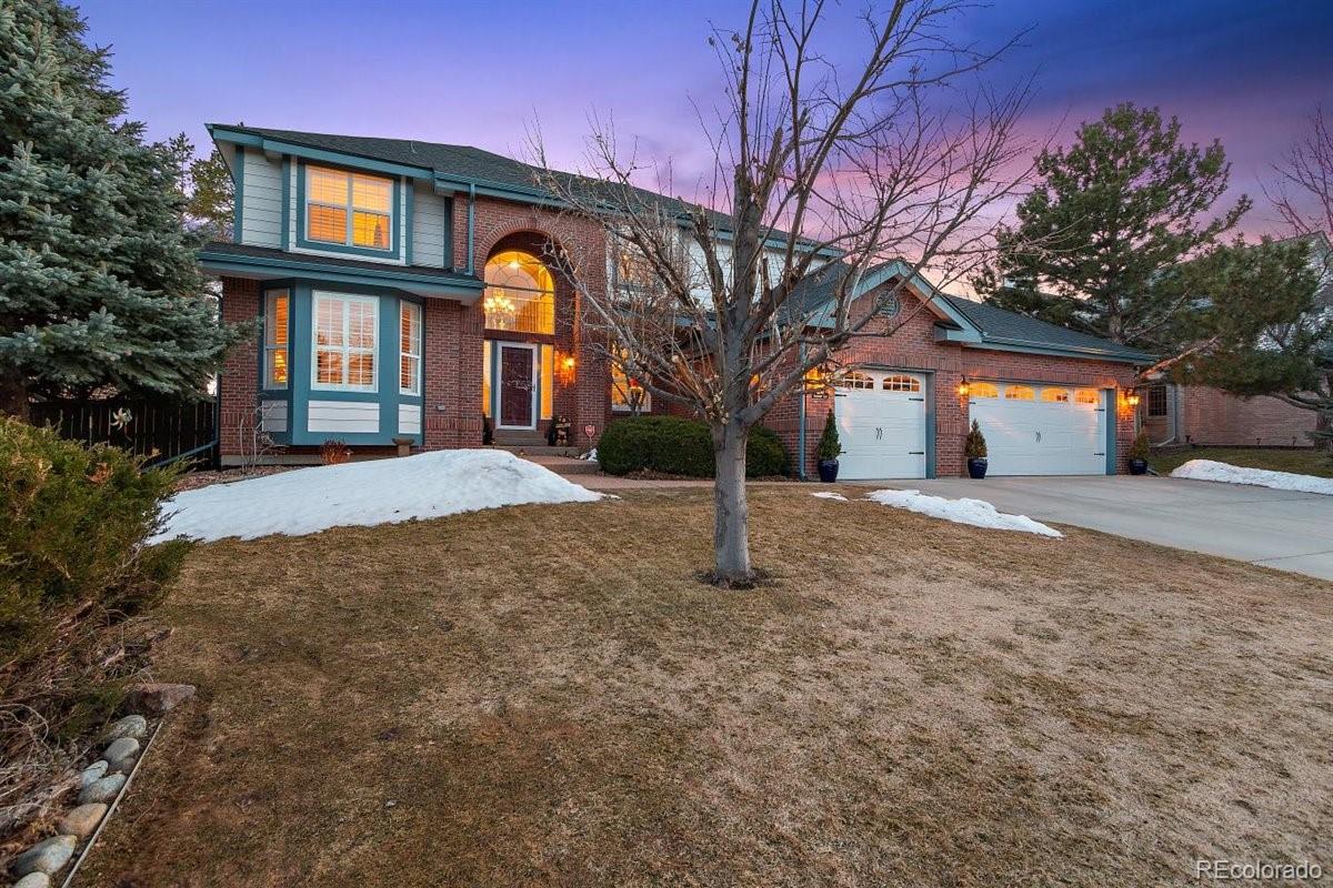 2290 Crestmont Lane Highlands Ranch, CO 80126 - Photo 2 of 40 a front view of a house with a yard and garage