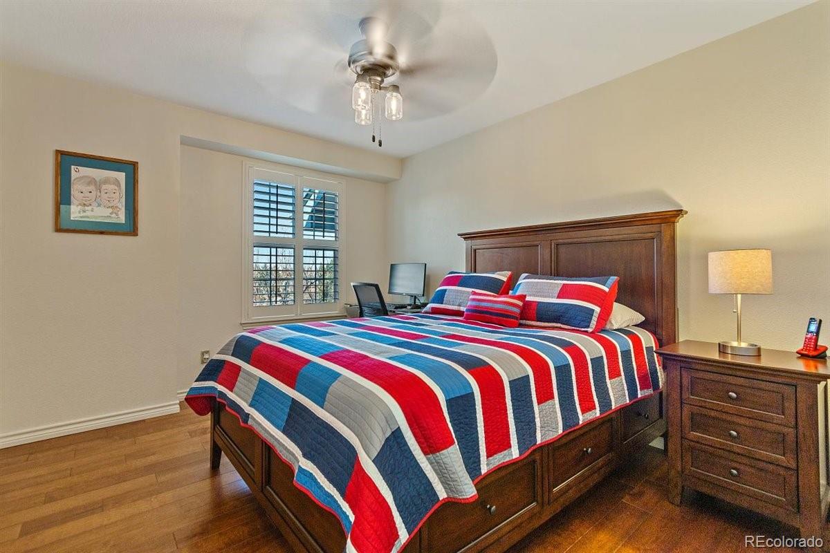 2290 Crestmont Lane Highlands Ranch, CO 80126 - Photo 23 of 40 a bedroom with a bed and a chandelier