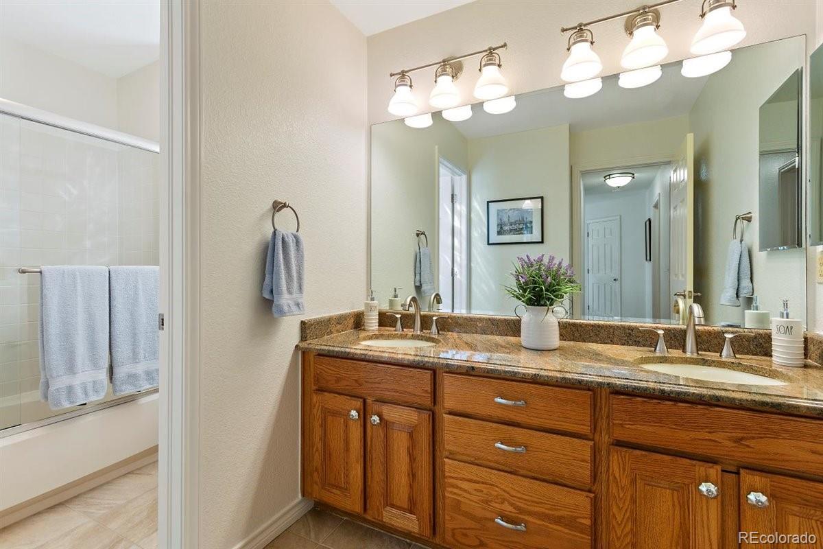 2290 Crestmont Lane Highlands Ranch, CO 80126 - Photo 25 of 40 a bathroom with a granite countertop double vanity sink and a mirror