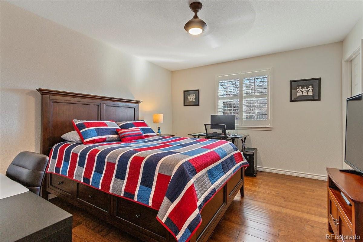 2290 Crestmont Lane Highlands Ranch, CO 80126 - Photo 26 of 40 a bedroom with a bed and wooden floor
