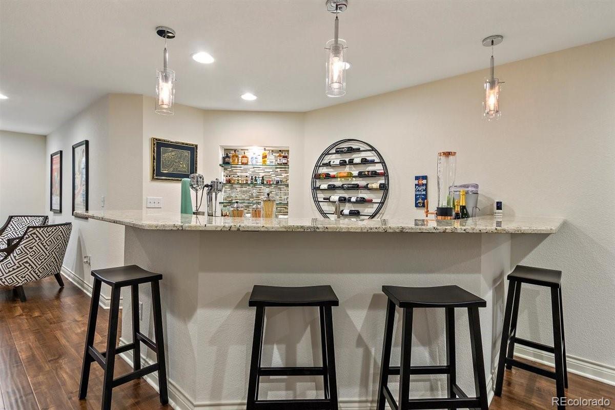2290 Crestmont Lane Highlands Ranch, CO 80126 - Photo 28 of 40 a kitchen with stainless steel appliances kitchen island a table and chairs in it