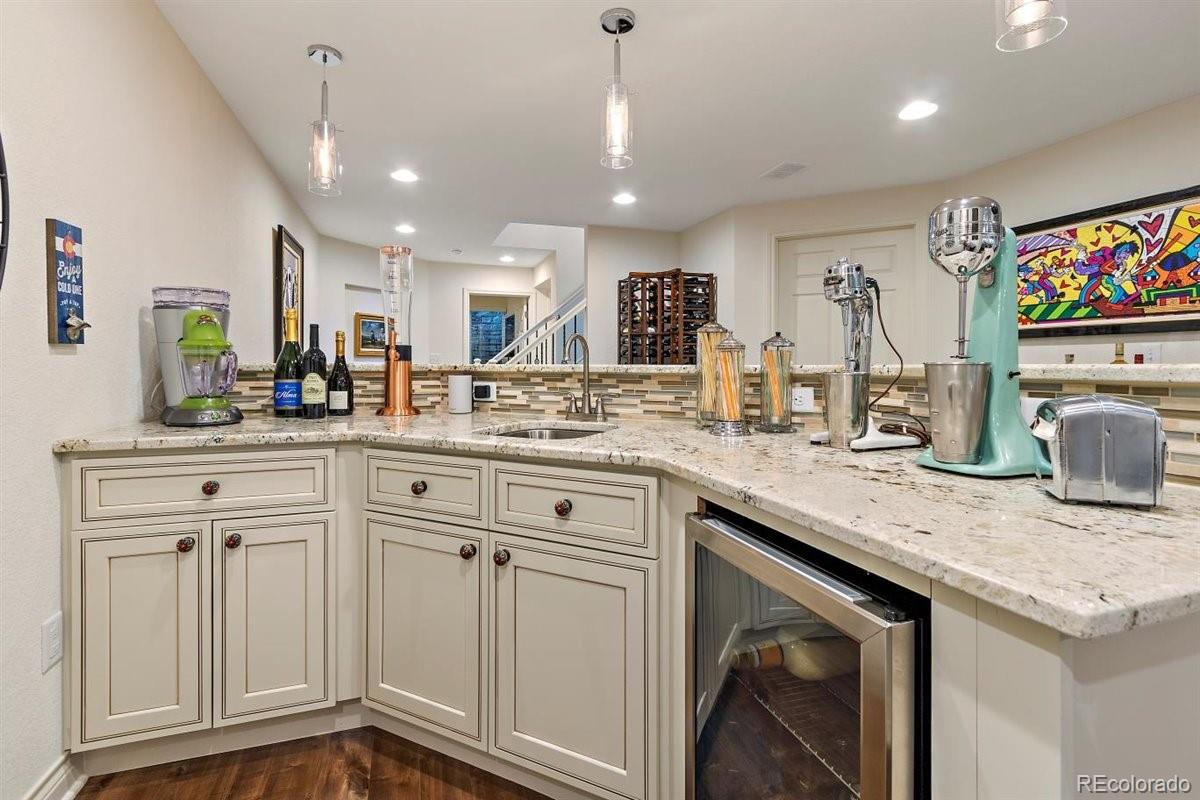 2290 Crestmont Lane Highlands Ranch, CO 80126 - Photo 29 of 40 a kitchen with white cabinets and sink