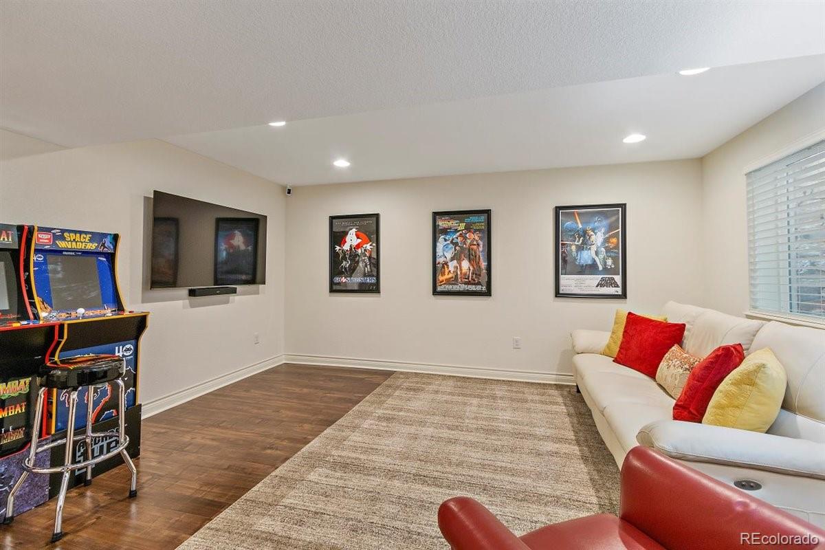 2290 Crestmont Lane Highlands Ranch, CO 80126 - Photo 32 of 40 a living room with furniture and a flat screen tv