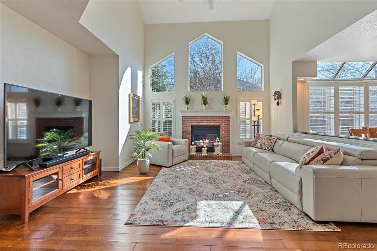 2290 Crestmont Lane Highlands Ranch, CO 80126 - Photo 5 of 40 a living room with furniture fireplace and flat screen tv