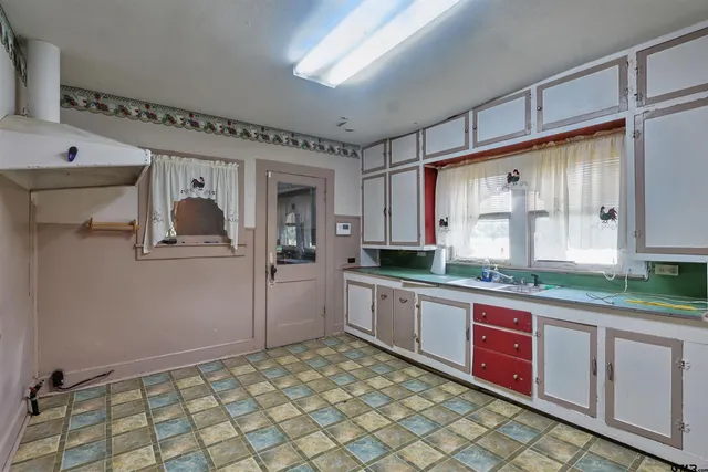 a kitchen with stainless steel appliances granite countertop a sink and cabinets