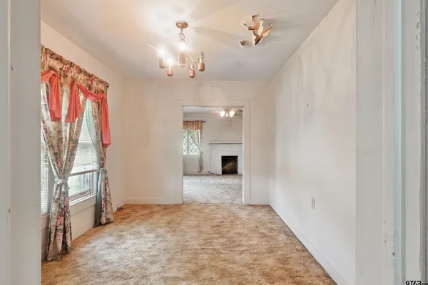 wooden floor in an empty room with a fireplace