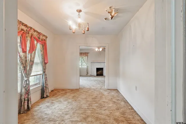 wooden floor in an empty room with a fireplace