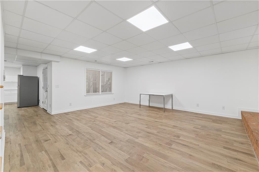 8965 Laurel Way Alpharetta, GA 30022 - Photo 43 of 79 a view of an empty room with window and wooden floor