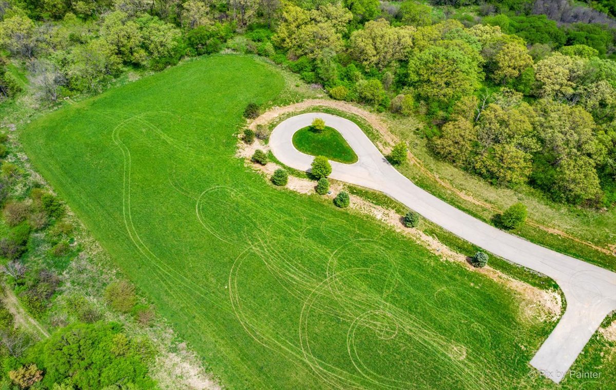 4411 Red Tail Lane Johnsburg, IL 60051 - Photo 25 of 26 a view of a swimming pool with a yard and large trees