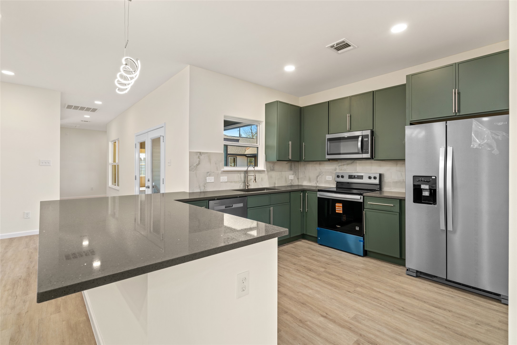 4656 North Teague Street Rosharon, TX 77583 - Photo 13 of 41 Designer kitchen with sleek cabinetry, quartz countertops, and stainless appliances.