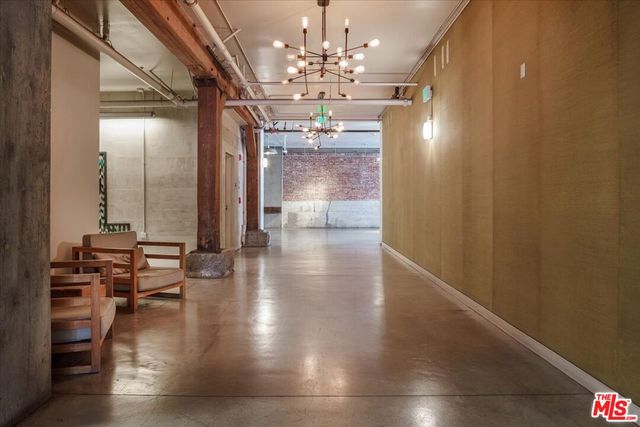 a view of a patio with table and chairs potted plants