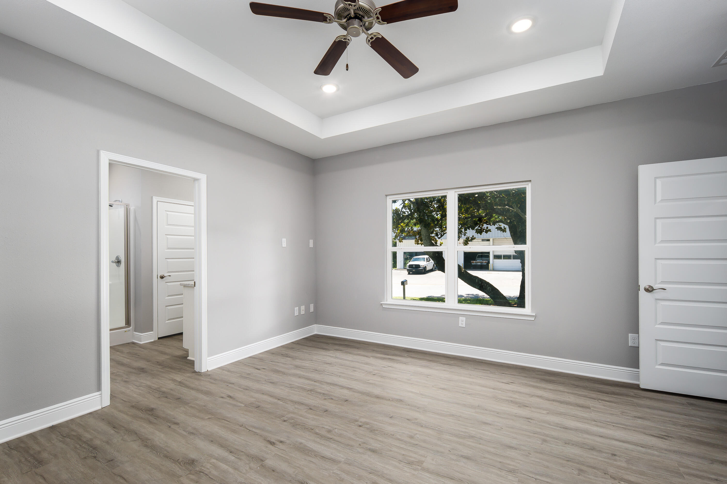 959 Skylark Road Mary Esther, FL 32569 - Photo 21 of 42 an empty room with wooden floor and windows