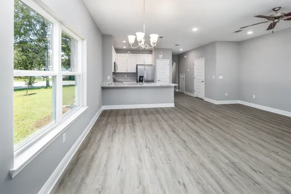 a view of a kitchen with kitchen island a sink stainless steel appliances and cabinets