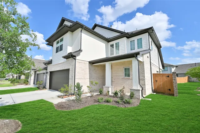 a front view of house with a garden and patio