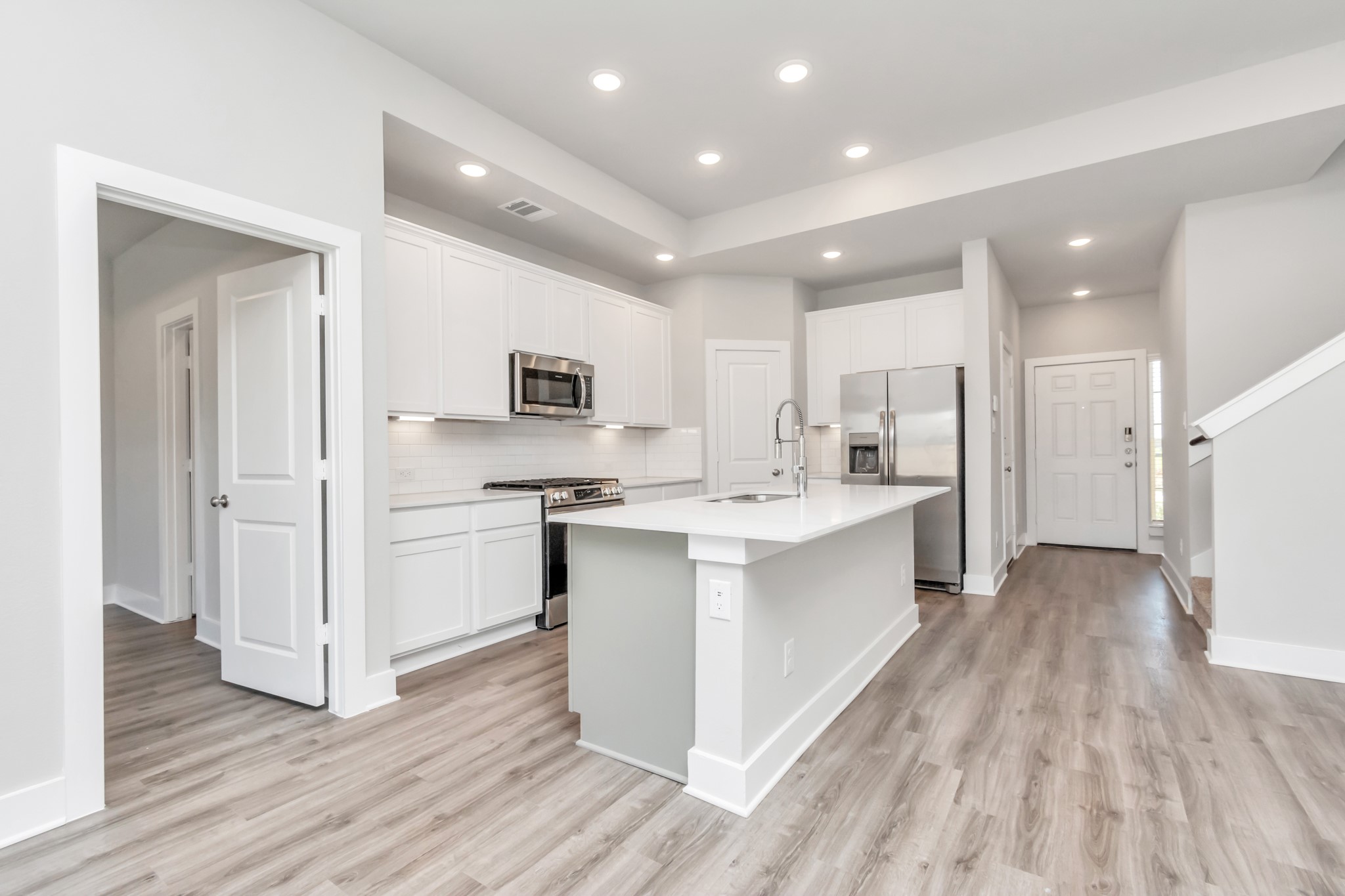 21059 Montego Breeze Lane Cypress, TX 77433 - Photo 4 of 23 a large white kitchen with a white countertops a stove a sink and a refrigerator