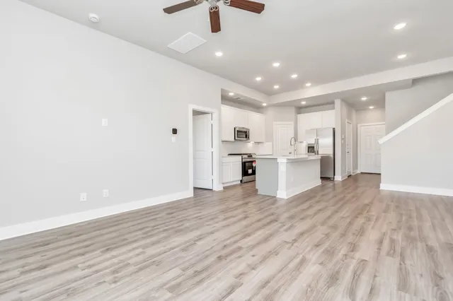 a view of kitchen with refrigerator microwave and stove